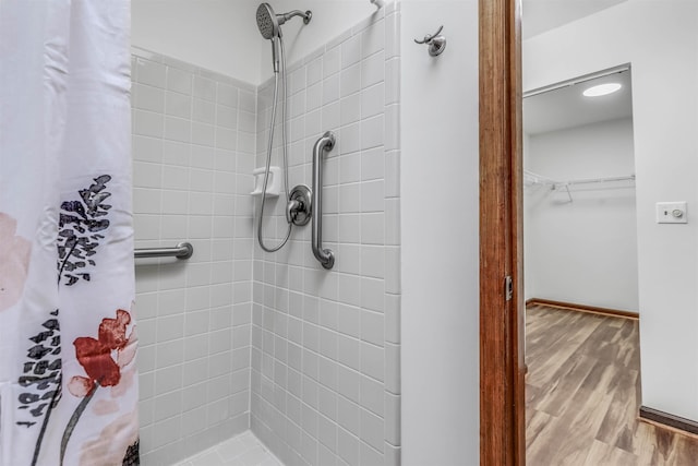 bathroom featuring hardwood / wood-style flooring and a shower with curtain