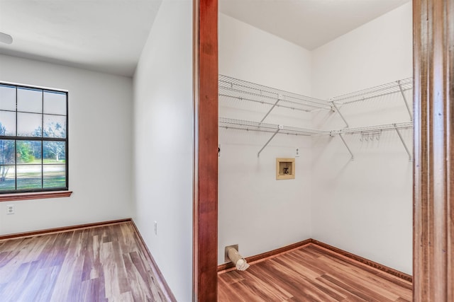 laundry room with washer hookup and hardwood / wood-style flooring