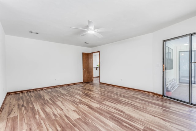 empty room featuring ceiling fan and light wood-type flooring