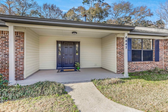 doorway to property featuring covered porch