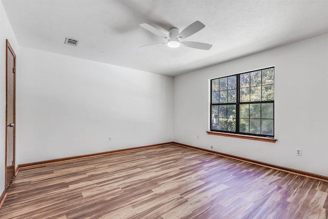 empty room featuring wood-type flooring and ceiling fan