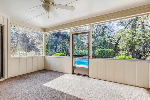 unfurnished sunroom with ceiling fan