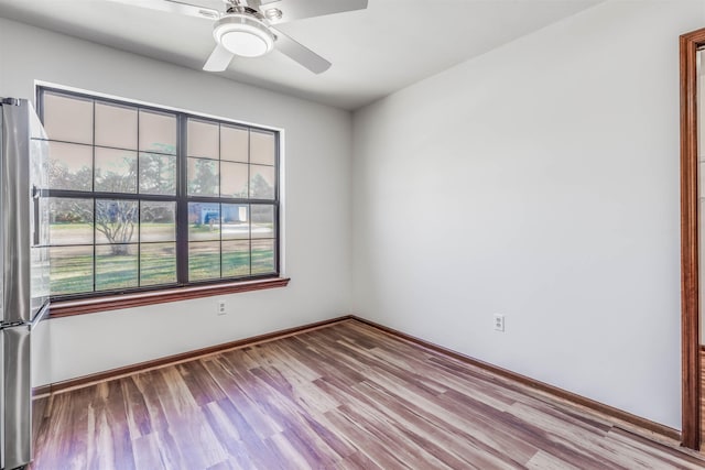 empty room featuring ceiling fan and light wood-type flooring