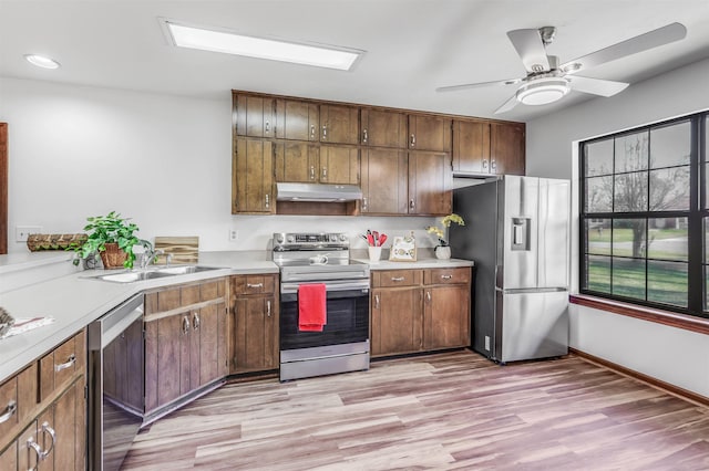 kitchen with sink, light wood-type flooring, ceiling fan, and appliances with stainless steel finishes