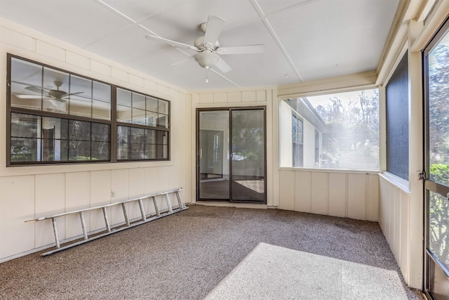 unfurnished sunroom with ceiling fan