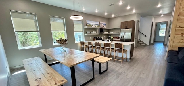 dining room featuring light wood-type flooring and sink