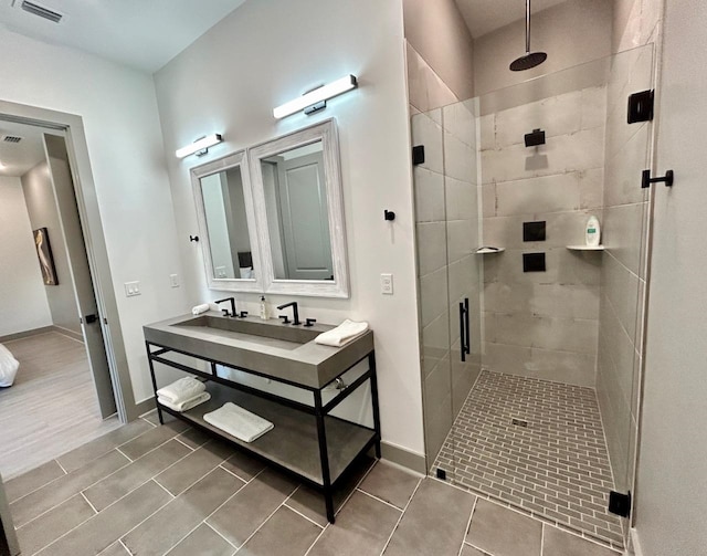 bathroom with hardwood / wood-style floors, vanity, and a shower with shower door