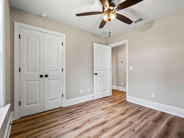 45 Sioux Trl, Crawfordville, FL 32327 - unfurnished bedroom featuring wood finished floors, a closet, baseboards, and ceiling fan