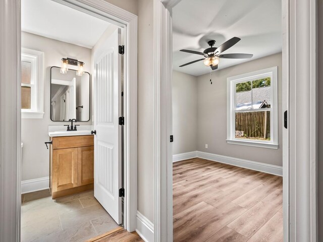 45 Sioux Trl, Crawfordville, FL 32327 - bathroom featuring vanity, a ceiling fan, baseboards, and wood finished floors