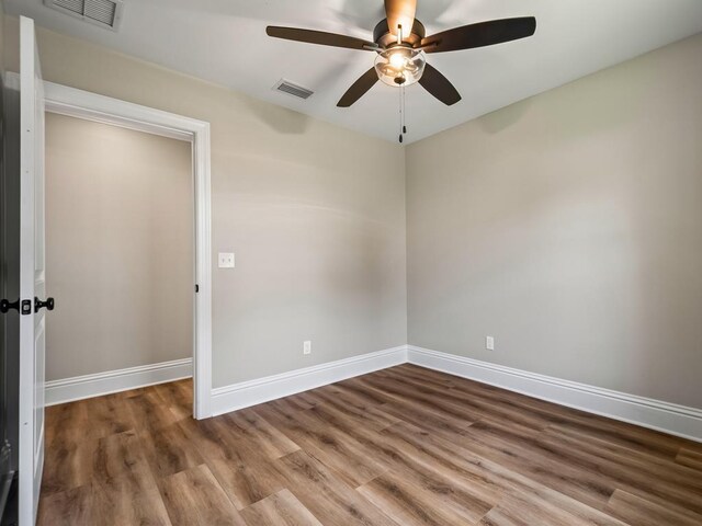 45 Sioux Trl, Crawfordville, FL 32327 - empty room featuring a ceiling fan, wood finished floors, and baseboards
