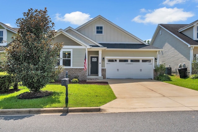 craftsman-style home with cooling unit, a garage, and a front yard