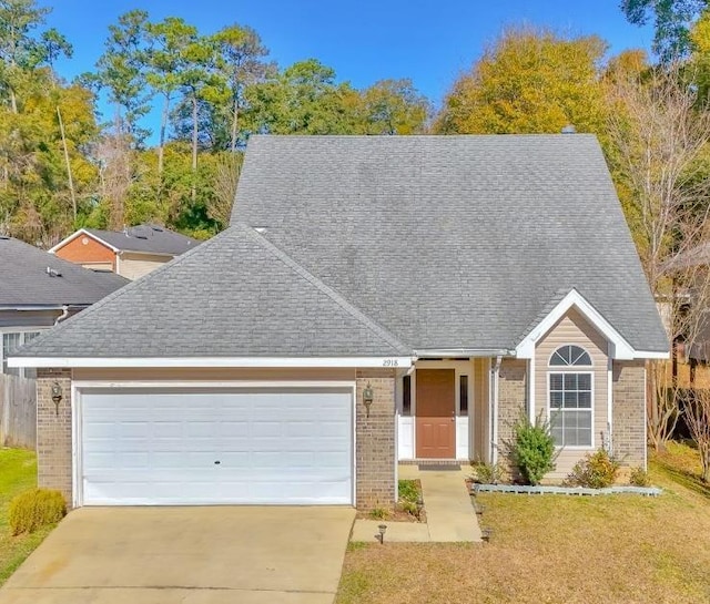 view of front of house featuring a garage and a front lawn