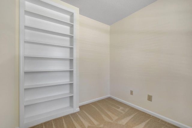 3024 S Shamrock, Tallahassee, FL 32309 - interior space with carpet floors, baseboards, vaulted ceiling, and built in shelves