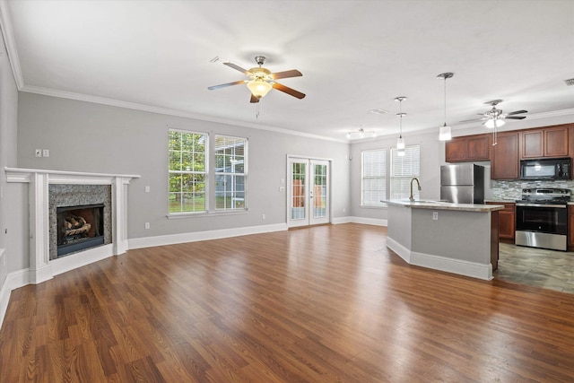 3770 Laurel Trace Way, Tallahassee, FL 32303 - unfurnished living room featuring ceiling fan, crown molding, wood finished floors, a fireplace, and baseboards