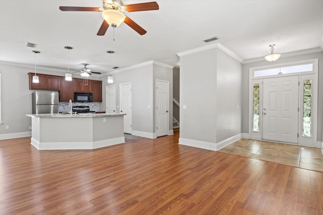 3770 Laurel Trace Way, Tallahassee, FL 32303 - foyer entrance featuring a ceiling fan, light wood-style flooring, crown molding, baseboards, and stairs