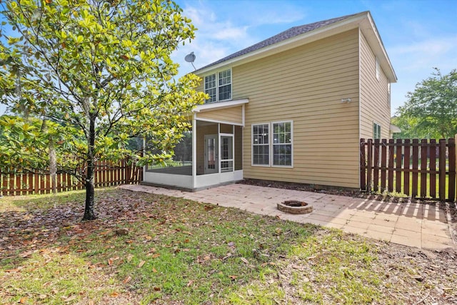 3770 Laurel Trace Way, Tallahassee, FL 32303 - rear view of house with a sunroom, a patio, an outdoor fire pit, and a fenced backyard