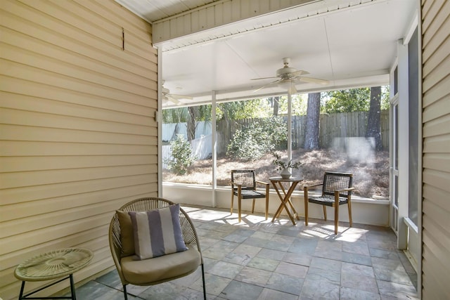 sunroom / solarium featuring ceiling fan