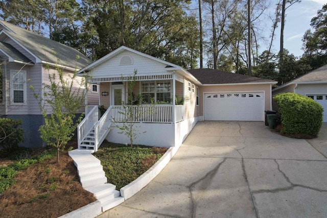 view of front facade with a porch, concrete driveway, and an attached garage