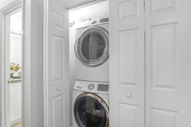 laundry room featuring laundry area and stacked washer and clothes dryer