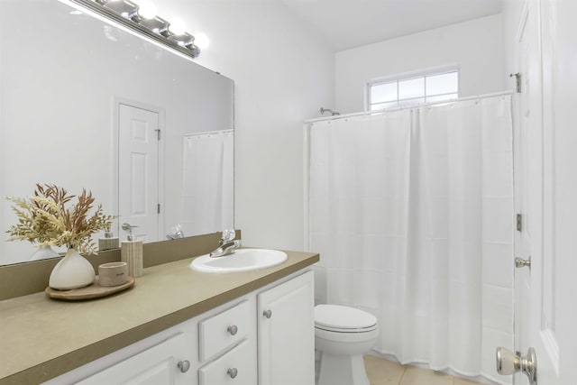 bathroom with tile patterned floors, toilet, vanity, and a shower with curtain