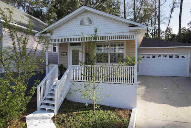 view of front facade with a porch, an attached garage, and concrete driveway