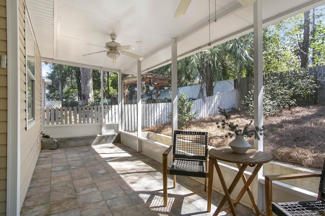 sunroom featuring ceiling fan