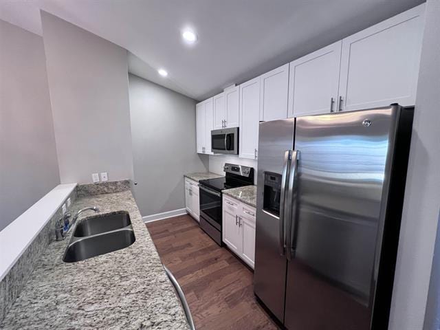 4783 Cypress Brooke Way Unit 4783 & 4787, Tallahassee, FL 32311 - kitchen featuring appliances with stainless steel finishes, dark wood-style flooring, white cabinetry, recessed lighting, and light stone countertops