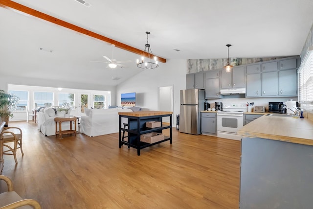 kitchen with stainless steel fridge, white range with electric cooktop, decorative light fixtures, sink, and light hardwood / wood-style floors