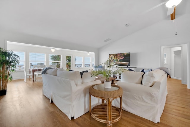 living room with high vaulted ceiling, light hardwood / wood-style flooring, and ceiling fan