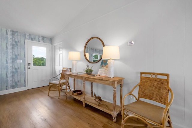 sitting room featuring lofted ceiling and wood-type flooring