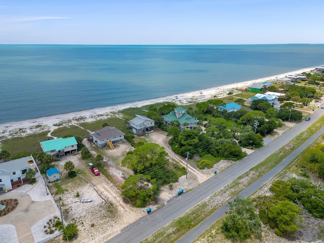 drone / aerial view featuring a water view and a view of the beach