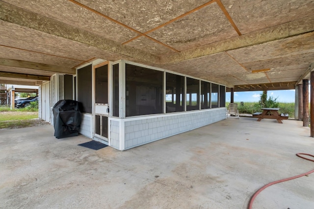 view of patio featuring area for grilling and a sunroom