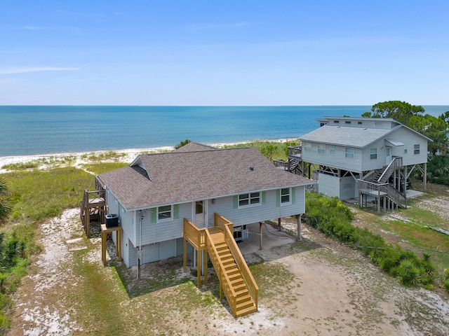 birds eye view of property with a beach view and a water view