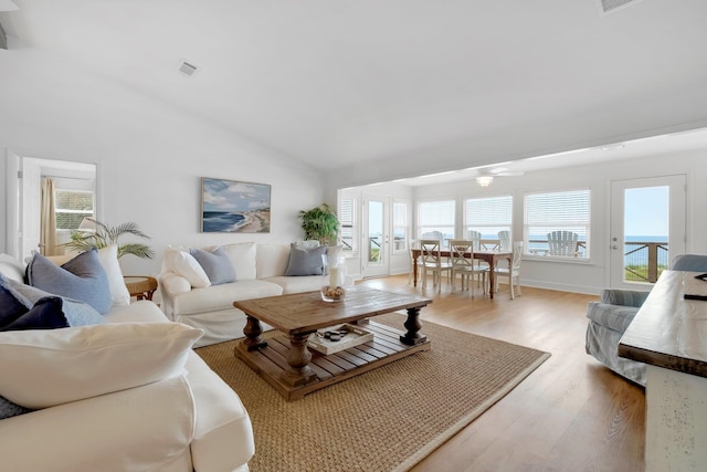 living room with vaulted ceiling and light hardwood / wood-style floors