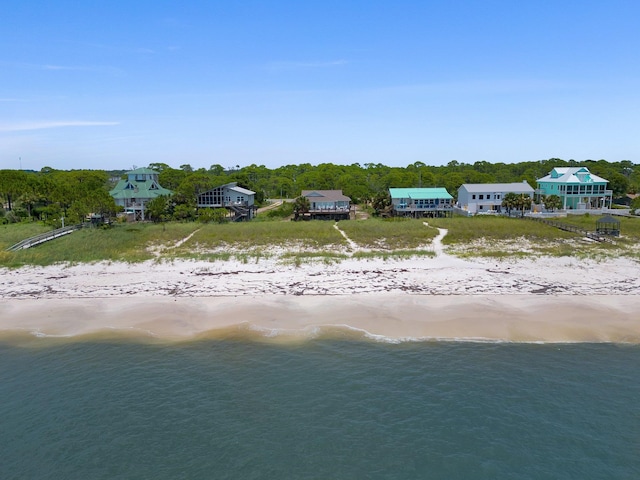 drone / aerial view with a beach view and a water view