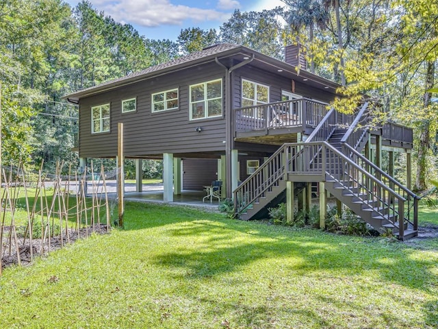 back of house featuring a deck and a lawn