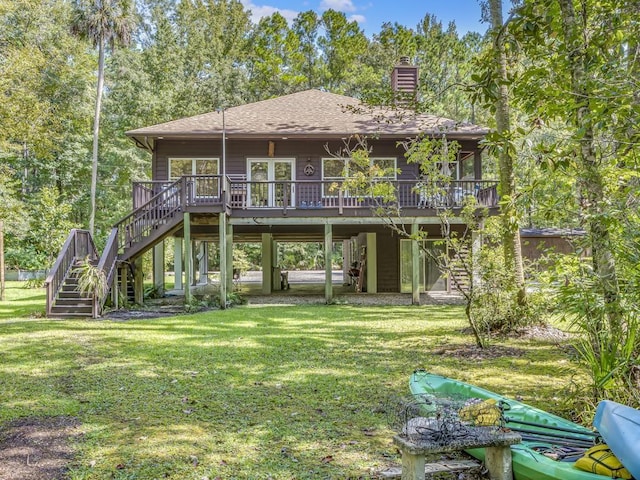 rear view of property with a yard and a deck