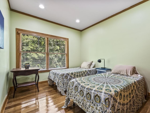 bedroom featuring crown molding and wood-type flooring