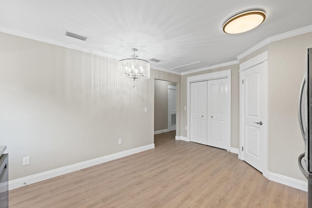 unfurnished bedroom featuring stainless steel fridge, a chandelier, light hardwood / wood-style flooring, and ornamental molding