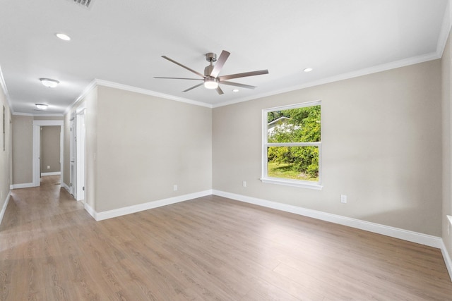 empty room with ornamental molding, light hardwood / wood-style floors, and ceiling fan