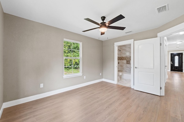 unfurnished bedroom featuring ensuite bathroom, ceiling fan, and light hardwood / wood-style flooring