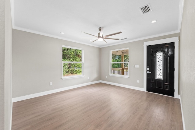 foyer entrance with ornamental molding, hardwood / wood-style floors, and ceiling fan