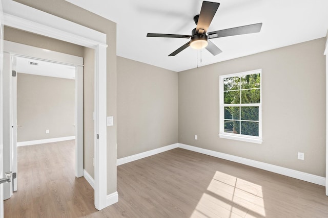 spare room with light hardwood / wood-style floors and ceiling fan