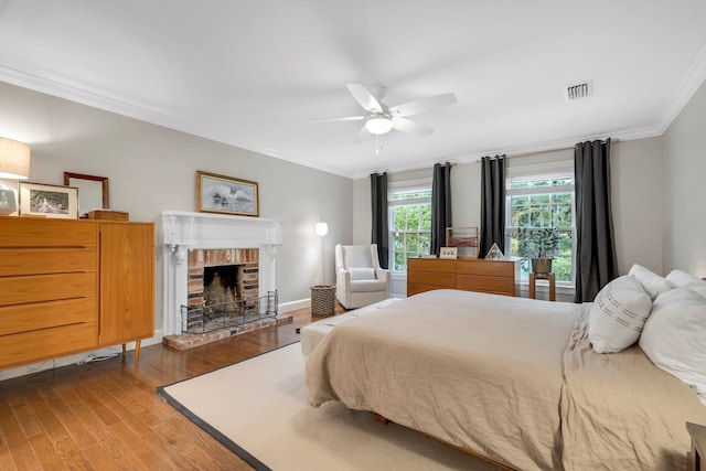 2003 Ellicott Dr, Tallahassee, FL 32308 - bedroom with crown molding, wood finished floors, a fireplace, and a ceiling fan