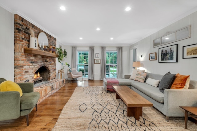 2003 Ellicott Dr, Tallahassee, FL 32308 - living room featuring ornamental molding, light wood finished floors, recessed lighting, and a brick fireplace