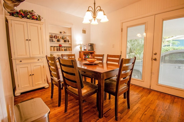 319 Gaile Ave, Tallahassee, FL 32305 - dining area featuring built in features, french doors, light wood-style flooring, and a notable chandelier