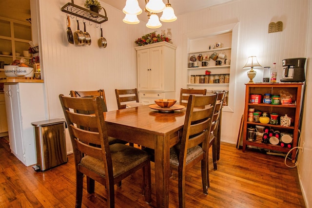319 Gaile Ave, Tallahassee, FL 32305 - dining room featuring a notable chandelier, built in shelves, and wood finished floors