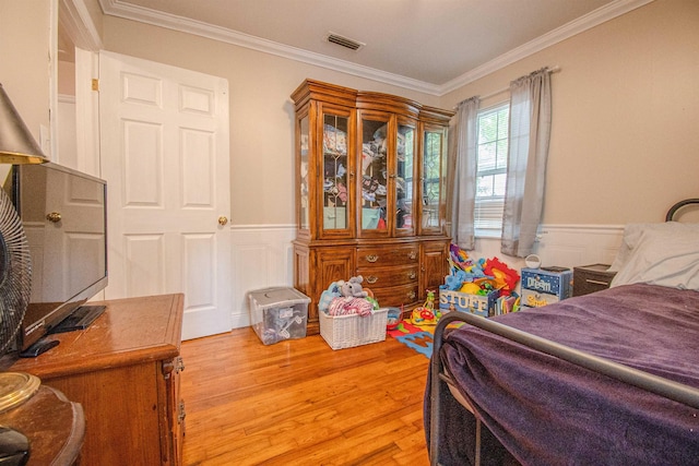 319 Gaile Ave, Tallahassee, FL 32305 - bedroom featuring visible vents, ornamental molding, light wood-style flooring, and a wainscoted wall
