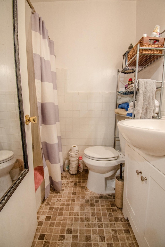 319 Gaile Ave, Tallahassee, FL 32305 - full bath with tile walls, vanity, toilet, and a shower with shower curtain