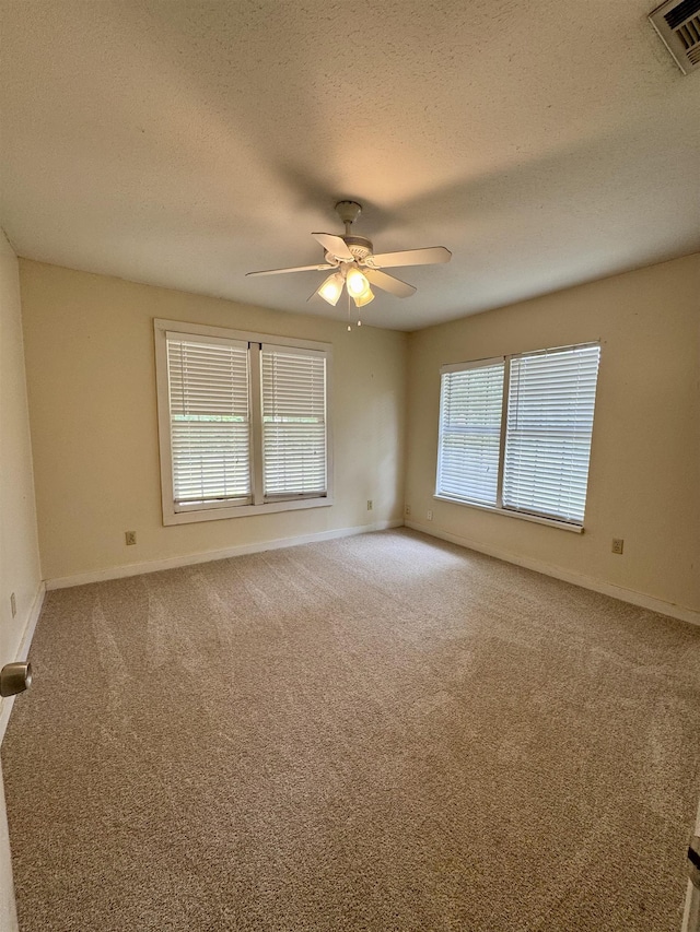 2755 Lake Bradford Rd, Tallahassee, FL 32310 - carpeted spare room with a ceiling fan, a textured ceiling, and baseboards